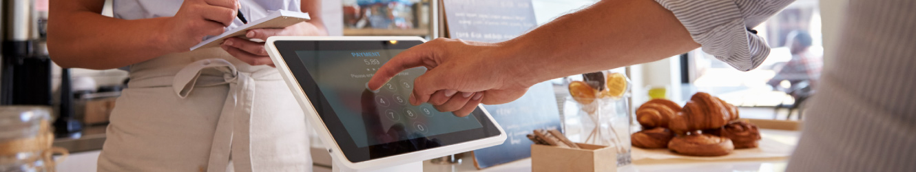 a person paying at a bakery