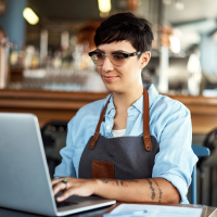 A business owner depositing a check with her computer